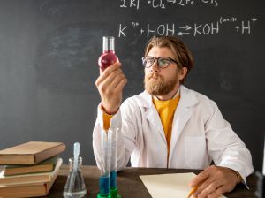 Nauczyciel chemii trzymający w dłoni probówkę